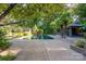 Expansive pool area with trees, lush landscaping, and an outdoor kitchen at 501 Journey Sw St, Concord, NC 28025