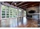 Spacious living room with hardwood floors, fireplace, and wall of windows at 501 Journey Sw St, Concord, NC 28025