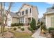 Two story tan home with landscaping and walkway at 607 Pine Links Dr, Tega Cay, SC 29708