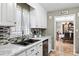 Bright kitchen features white cabinets, marble countertops, and a tile backsplash at 283 Alpine Cir, Statesville, NC 28625