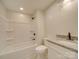 Bathroom with a bathtub, toilet and granite countertop at 3980 Fish Pond Rd, Salisbury, NC 28146