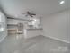 Open concept living room with kitchen and grey tile flooring at 3980 Fish Pond Rd, Salisbury, NC 28146