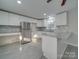 Modern kitchen with white cabinets, granite counters, and stainless steel appliances at 3980 Fish Pond Rd, Salisbury, NC 28146
