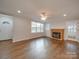 Spacious living room featuring hardwood floors, a brick fireplace and French doors at 3980 Fish Pond Rd, Salisbury, NC 28146