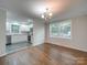 Bright dining room with hardwood floors and view into the updated kitchen at 3980 Fish Pond Rd, Salisbury, NC 28146