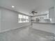 Open living room and kitchen with grey tile floors and ceiling fan at 3980 Fish Pond Rd, Salisbury, NC 28146