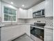 Modern kitchen with white cabinets, granite countertops, and stainless steel appliances at 3980 Fish Pond Rd, Salisbury, NC 28146