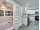 Modern kitchen with white cabinets and sunroom access at 3980 Fish Pond Rd, Salisbury, NC 28146