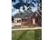 Brick ranch house with a sunroom and landscaping at 3980 Fish Pond Rd, Salisbury, NC 28146