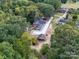 Aerial view showing house, driveway, and surrounding trees at 3980 Fish Pond Rd, Salisbury, NC 28146