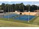 Two well-maintained blue basketball courts with seating at 102 Elm St # 94, New London, NC 28127