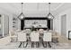 Elegant dining room features a large wooden table with white chairs and modern light fixtures at 5428 Carmel Rd, Charlotte, NC 28226