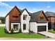 Stunning two-story home boasts a modern design, attached garage, and manicured lawn at 5428 Carmel Rd, Charlotte, NC 28226