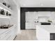 Modern kitchen features white and dark cabinetry, wine storage, and a large island at 5428 Carmel Rd, Charlotte, NC 28226