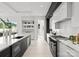 Modern kitchen with stainless steel appliances and marble countertops. View of backyard at 5428 Carmel Rd, Charlotte, NC 28226