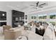 Open living room with modern fireplace and large windows at 5428 Carmel Rd, Charlotte, NC 28226