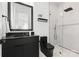 Modern bathroom with black vanity, frameless shower, and marble at 5428 Carmel Rd, Charlotte, NC 28226