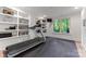 Basement home gym with treadmill and built-in shelving at 235 Grey Rd, Davidson, NC 28036