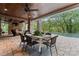 Outdoor patio area with dining table and built in fireplace next to pool at 235 Grey Rd, Davidson, NC 28036