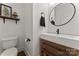 Stylish bathroom with floating vanity and round mirror at 235 Grey Rd, Davidson, NC 28036