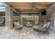 Relaxing covered patio with seating area and fireplace near the pool at 235 Grey Rd, Davidson, NC 28036