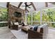 Relaxing screened porch with stone fireplace and wicker furniture at 235 Grey Rd, Davidson, NC 28036
