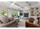 Bright living room with a stone fireplace, built-in shelving, and coffered ceiling at 235 Grey Rd, Davidson, NC 28036