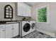 Convenient laundry room with washer, dryer, and built-in cabinets at 235 Grey Rd, Davidson, NC 28036