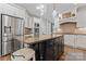 Modern kitchen with a large island, stainless steel appliances, and white cabinetry at 235 Grey Rd, Davidson, NC 28036