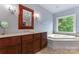 Luxurious bathroom with soaking tub, walk-in shower, and modern vanity at 235 Grey Rd, Davidson, NC 28036