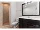 Basement bathroom with shower, toilet and dark vanity at 235 Grey Rd, Davidson, NC 28036