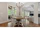 Bright dining room features a wooden table with seating for six and large windows at 235 Grey Rd, Davidson, NC 28036