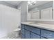 Modern bathroom with blue vanity and patterned tile floor at 235 Grey Rd, Davidson, NC 28036