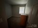 Simple bedroom with carpeted floor, window, and dresser at 3941 Briarhill Dr, Charlotte, NC 28215