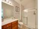 Clean bathroom with a shower/tub combo, vanity with drawers, and a mirror at 11719 Ridgeway Park Dr, Charlotte, NC 28277