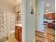 Charming bathroom with a shower, toilet and vanity with a view into the kitchen at 11719 Ridgeway Park Dr, Charlotte, NC 28277