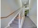 Clean carpeted stairwell with wooden handrail at 11719 Ridgeway Park Dr, Charlotte, NC 28277