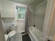 Updated bathroom with a tub/shower combination and gray tile at 2346 Timberland Hills Dr, Newton, NC 28658