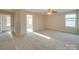 Well-lit bedroom with carpet and access to another room at 131 Renville Pl, Mooresville, NC 28115