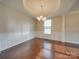 Bright dining room features hardwood floors, crown molding, and a chandelier at 131 Renville Pl, Mooresville, NC 28115