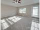 Bright bedroom featuring carpet flooring and a private door at 131 Renville Pl, Mooresville, NC 28115