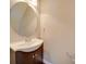 Small bathroom with dark vanity, round mirror, and neutral walls at 131 Renville Pl, Mooresville, NC 28115