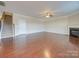 Living room features hardwood floors, fireplace, and a view of the staircase at 131 Renville Pl, Mooresville, NC 28115