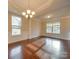Sunlit dining room boasts hardwood floors and an elegant chandelier at 131 Renville Pl, Mooresville, NC 28115