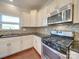 Kitchen features granite countertops, stainless steel appliances, and white cabinets at 131 Renville Pl, Mooresville, NC 28115