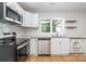 Modern kitchen featuring white cabinets and granite countertops at 1946 Monitor Ln, Lancaster, SC 29720