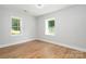 Spacious bedroom with hardwood floors and two windows at 1946 Monitor Ln, Lancaster, SC 29720