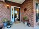 Brick front entrance with storm door and welcoming decor at 1011 Ratchford Rd, York, SC 29745