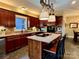 Kitchen boasts a large island with seating, stainless steel appliances, and dark wood cabinets at 1011 Ratchford Rd, York, SC 29745
