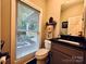 Simple bathroom with single vanity, toilet, and window with blinds at 1011 Ratchford Rd, York, SC 29745